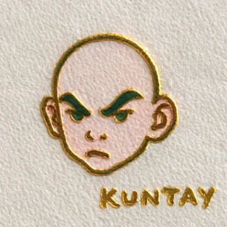 Kuntay Kunt: a drawing of a bald, frowning character with “KUNTAY” in gold foil.